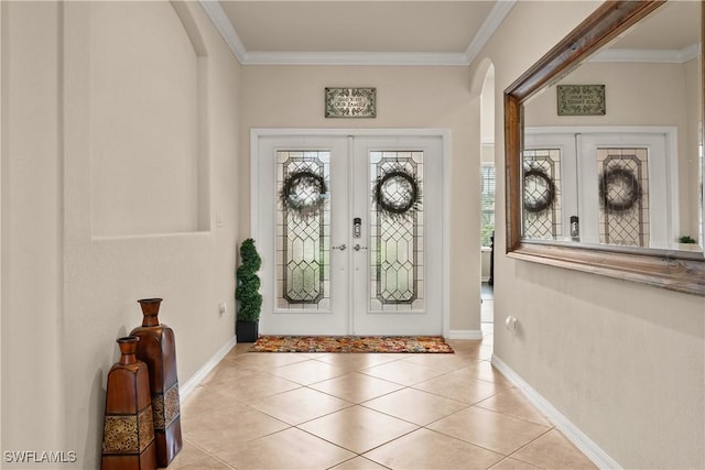 foyer featuring ornamental molding, french doors, a wealth of natural light, and baseboards