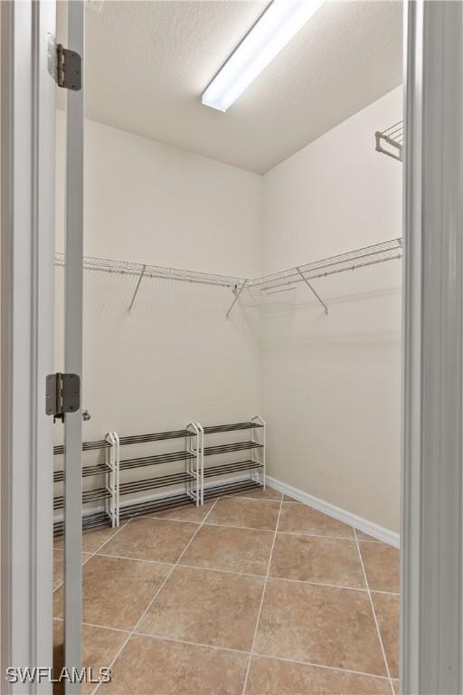 spacious closet with tile patterned flooring