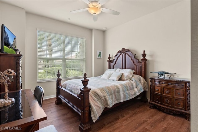 bedroom featuring baseboards, a ceiling fan, and dark wood-style flooring