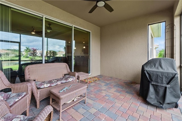 view of patio / terrace with a grill, an outdoor living space, and a ceiling fan