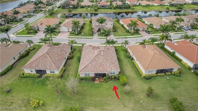 bird's eye view featuring a water view and a residential view