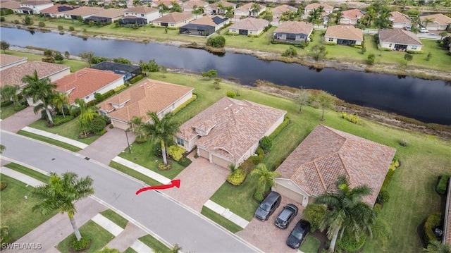 birds eye view of property featuring a residential view and a water view