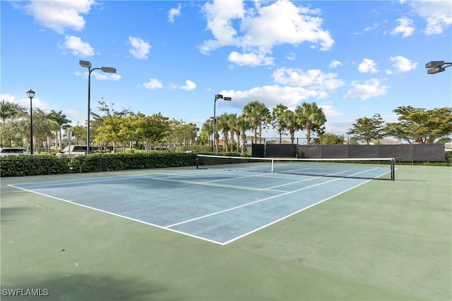 view of tennis court with fence