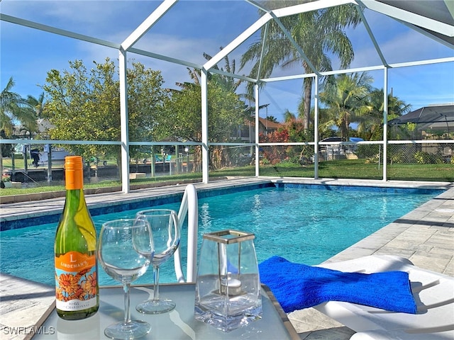 pool with a lanai and a patio area