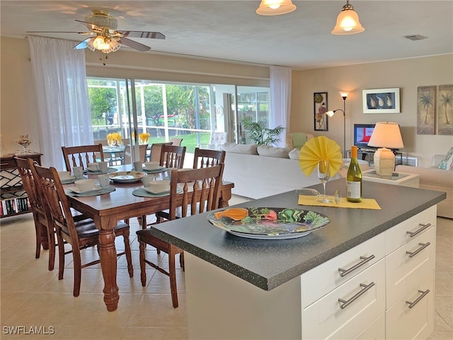 dining room with light tile patterned floors, visible vents, and a ceiling fan