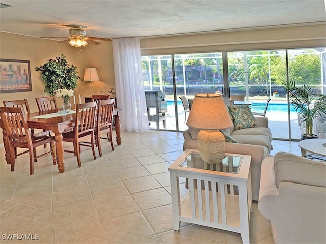 living room with a ceiling fan, a healthy amount of sunlight, and light tile patterned floors