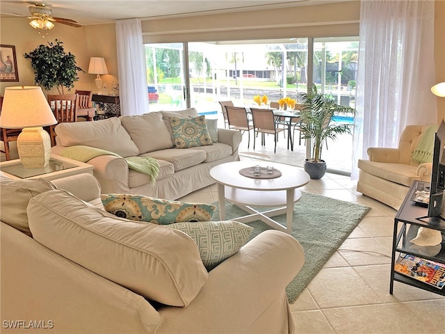 living area featuring tile patterned flooring and ceiling fan