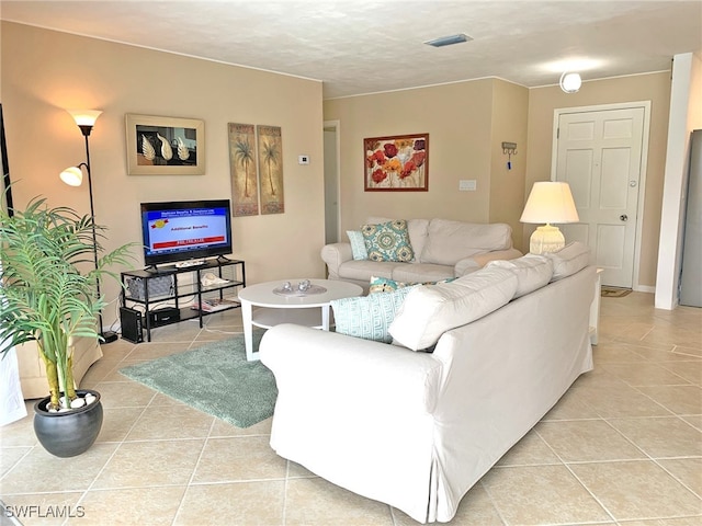 living area with visible vents and light tile patterned flooring