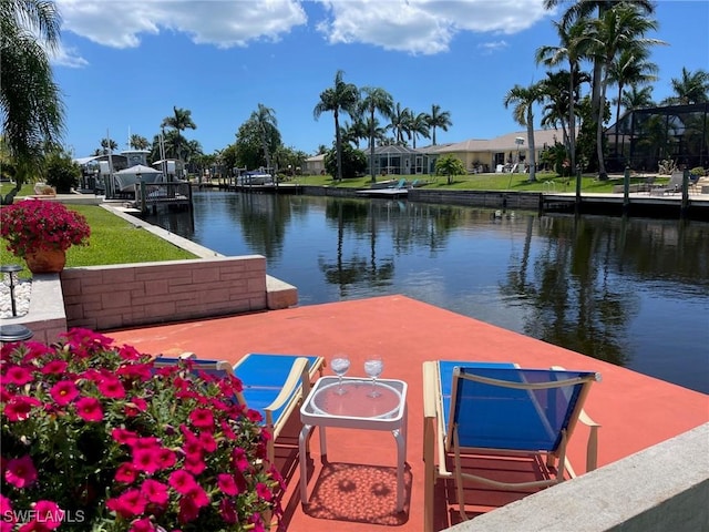 view of dock with a residential view and a water view