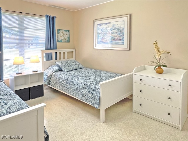 bedroom with light colored carpet