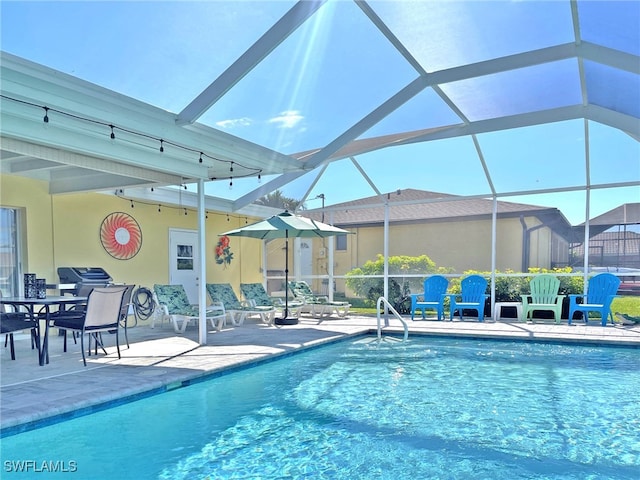 outdoor pool with a lanai and a patio