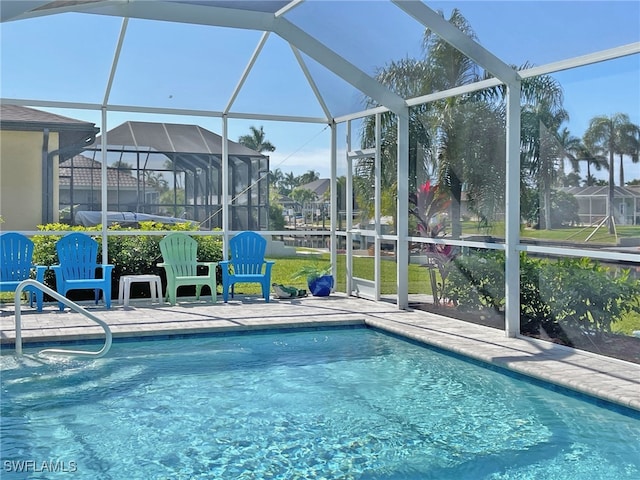 outdoor pool featuring a lanai and a patio area