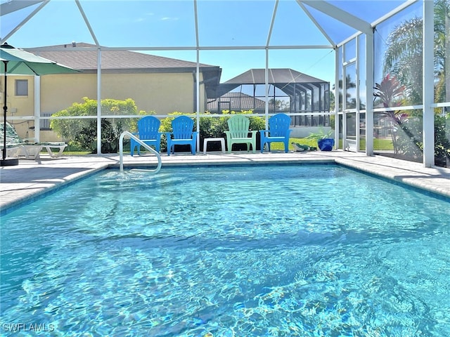 outdoor pool with a lanai and a patio area