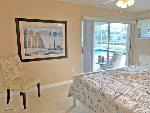 bedroom with light carpet, access to outside, and baseboards