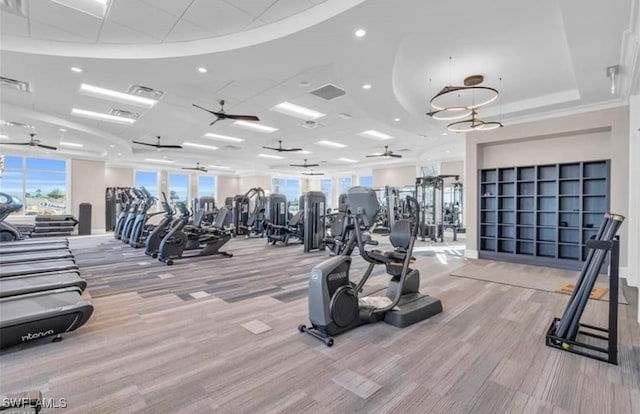 exercise room with visible vents and a ceiling fan