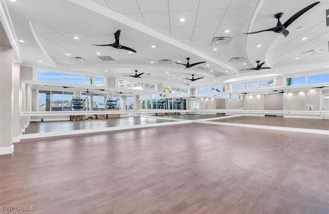 interior space featuring ceiling fan, wood finished floors, and visible vents