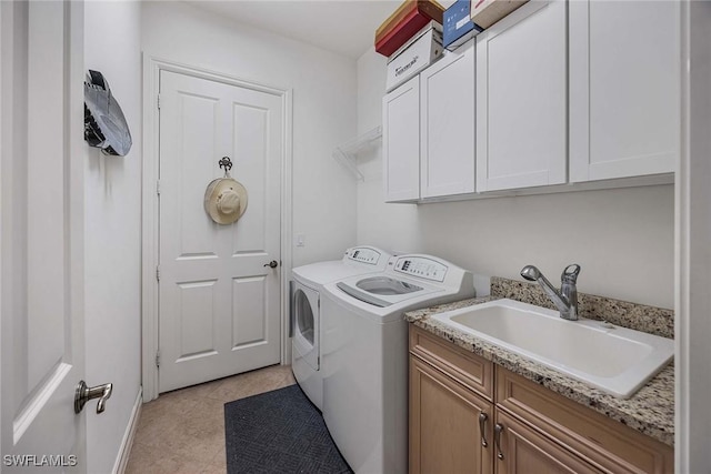 6574 Caldecott Dr, Naples, FL 34113 - clothes washing area with cabinet space, a sink, washing machine and clothes dryer, and light tile patterned floors