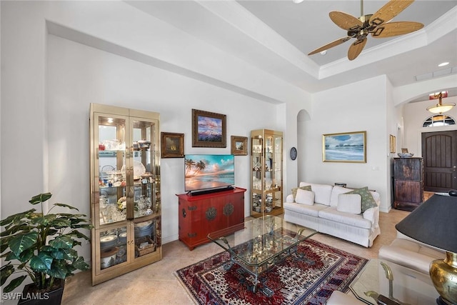 6574 Caldecott Dr, Naples, FL 34113 - living area featuring arched walkways, a tray ceiling, a ceiling fan, and crown molding