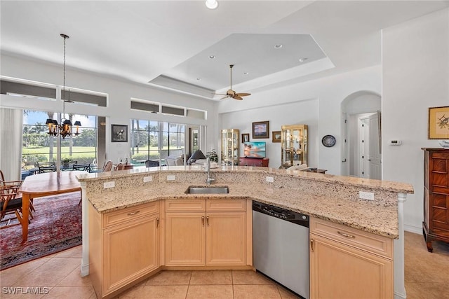 6574 Caldecott Dr, Naples, FL 34113 - kitchen with a raised ceiling, an island with sink, open floor plan, stainless steel dishwasher, and a sink