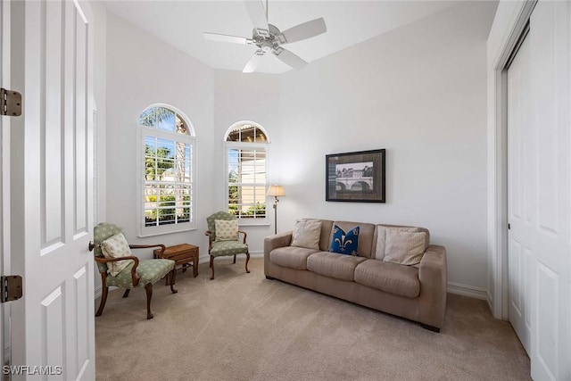 6574 Caldecott Dr, Naples, FL 34113 - living area featuring light carpet, ceiling fan, a towering ceiling, and baseboards