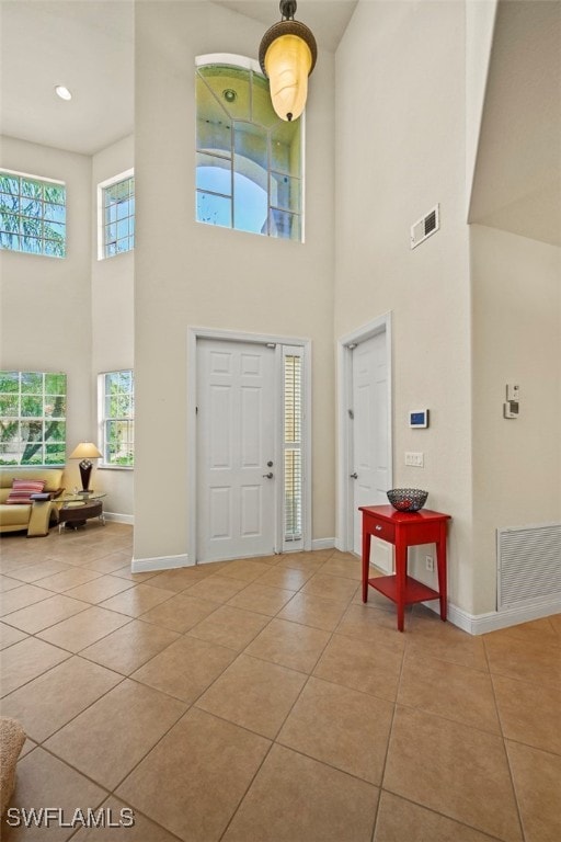 entryway with visible vents, baseboards, and light tile patterned floors