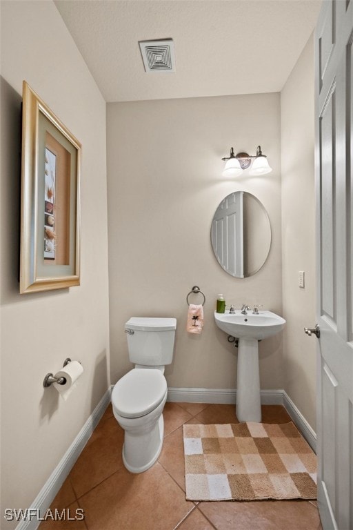 bathroom featuring visible vents, tile patterned flooring, toilet, and baseboards