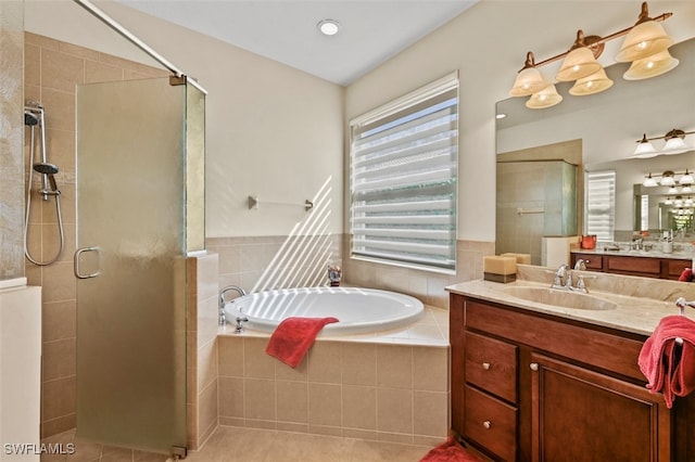 full bath featuring a garden tub, a shower stall, vanity, and tile patterned floors