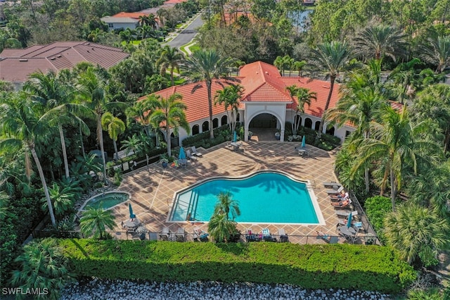 community pool featuring a patio and a hot tub