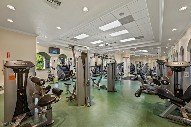 exercise room featuring a tray ceiling, recessed lighting, visible vents, and crown molding