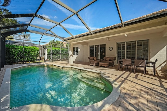 pool with a patio, outdoor lounge area, a lanai, and a ceiling fan