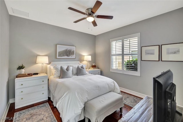 bedroom with visible vents, dark wood finished floors, baseboards, and ceiling fan