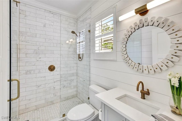 bathroom featuring toilet, a shower stall, ornamental molding, and vanity