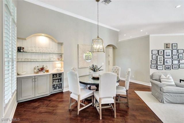 dining room featuring baseboards, arched walkways, dark wood-style floors, ornamental molding, and recessed lighting