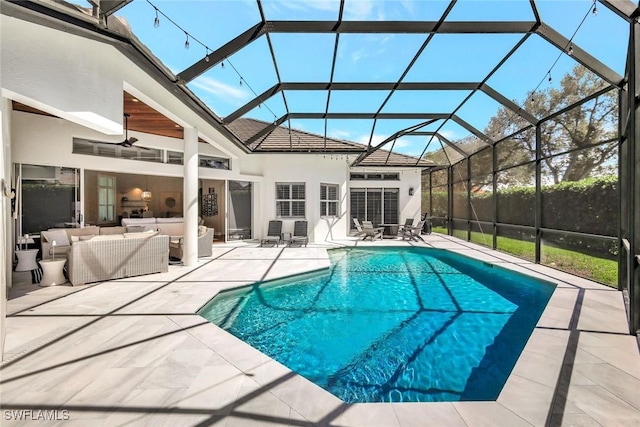 view of pool with glass enclosure, an outdoor hangout area, a ceiling fan, a fenced in pool, and a patio area