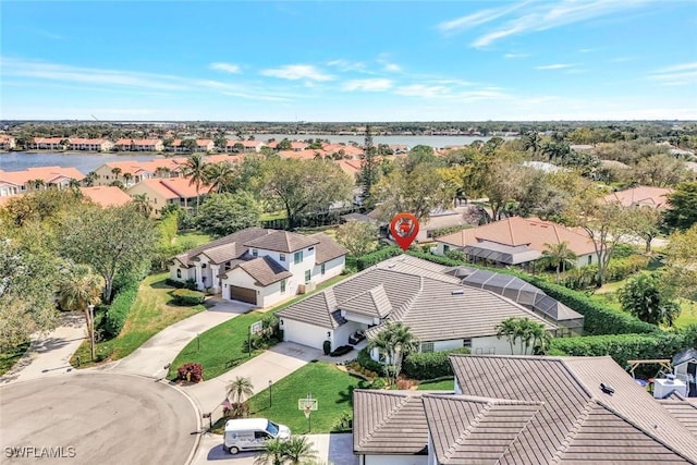 drone / aerial view featuring a water view and a residential view