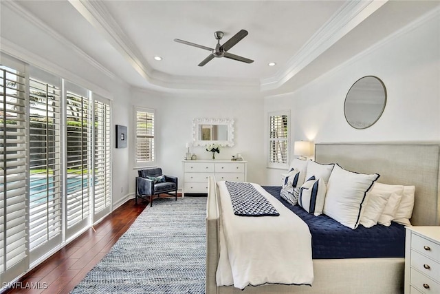 bedroom featuring dark wood-style floors, access to exterior, crown molding, recessed lighting, and a raised ceiling