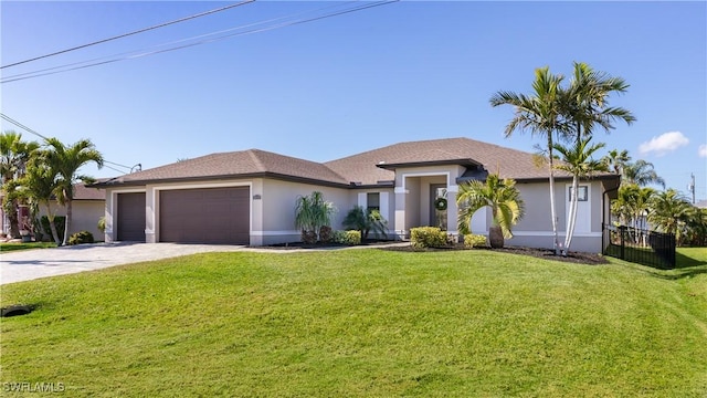 view of front facade with an attached garage, driveway, a front lawn, and stucco siding