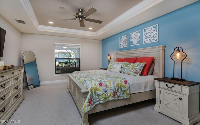 bedroom featuring a tray ceiling, recessed lighting, visible vents, ornamental molding, and light carpet