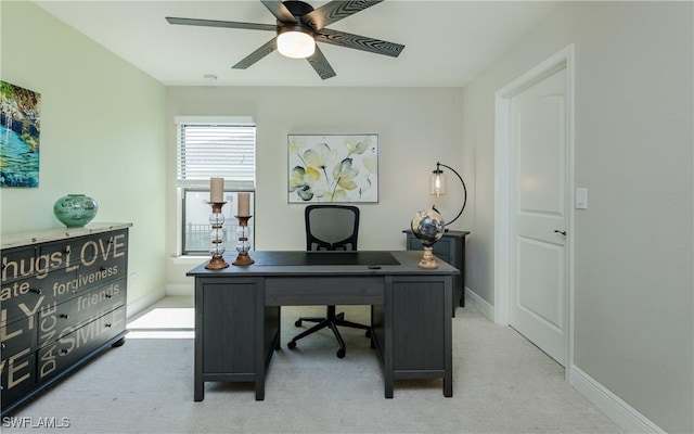 carpeted office featuring ceiling fan and baseboards