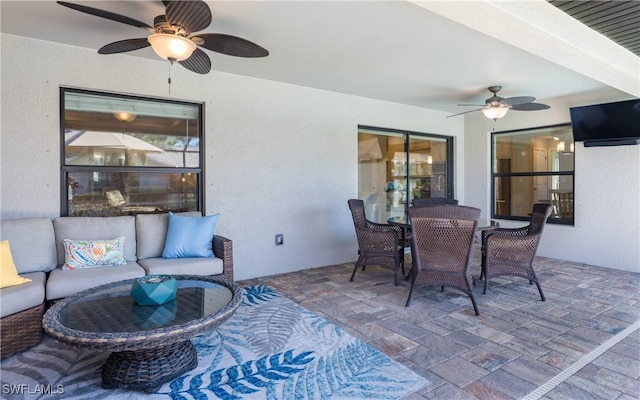 view of patio with an outdoor hangout area, a ceiling fan, and outdoor dining space