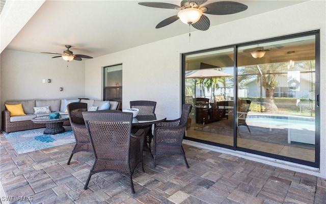 view of patio with a ceiling fan, an outdoor pool, and an outdoor living space