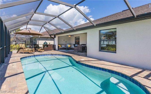 pool featuring glass enclosure, a patio, and an outdoor living space