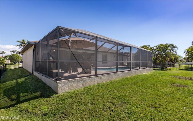 view of swimming pool with a lanai, a fenced backyard, a lawn, and a fenced in pool