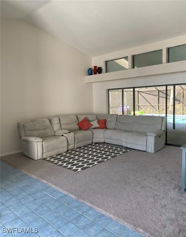 unfurnished living room with carpet floors and vaulted ceiling