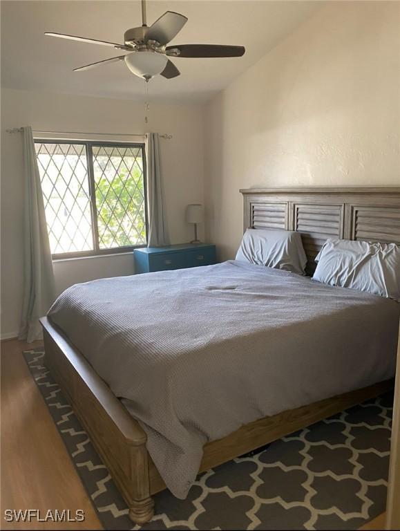 bedroom with wood finished floors and ceiling fan