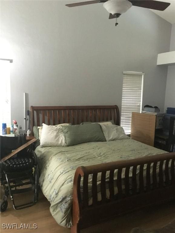 bedroom with wood finished floors, a ceiling fan, and vaulted ceiling