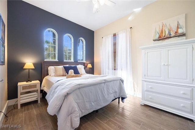 bedroom with a ceiling fan, wood tiled floor, and baseboards