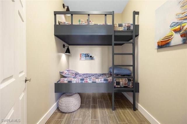 bedroom with wood tiled floor and baseboards