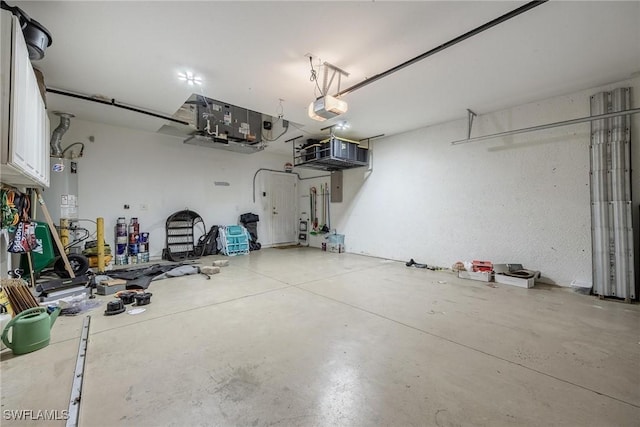 garage featuring a garage door opener and water heater