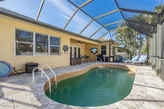 pool featuring a patio, french doors, a lanai, and a ceiling fan